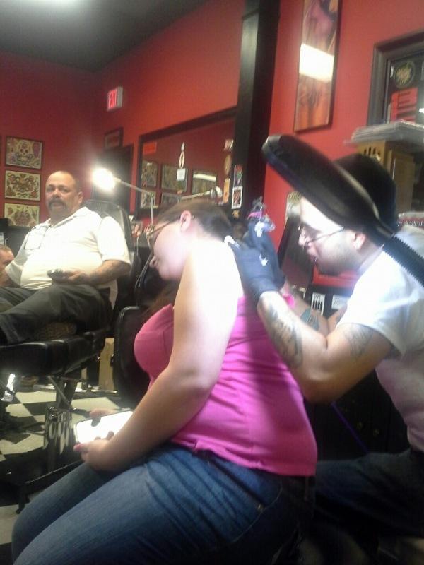 Senior Christina Justice prepares herself for the pain as she toughs it out for her first tattoo.