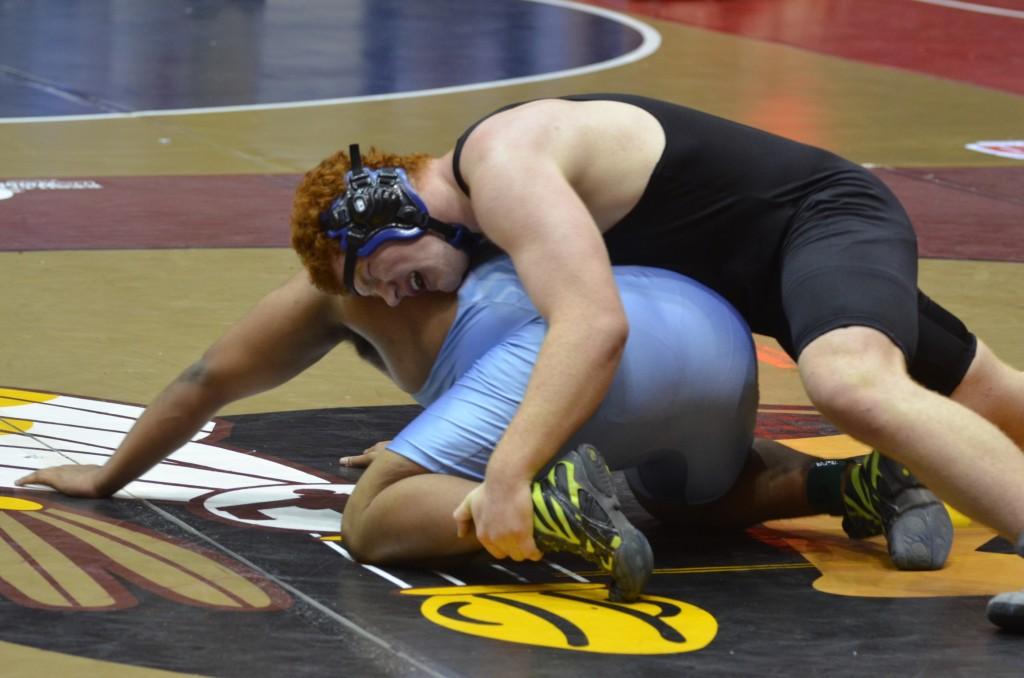 Junior Alex Ashley (in black) takes on his opponent, Whitewater's George Harris, in the 2013 wrestling state championships. Ashley won their heavyweight match.  