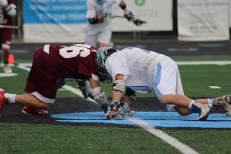 Sophomore Brett Berkey prepares to face-off against a Cadet player. The Panthers won the majority of the face-offs, keeping the ball on their side of the field.