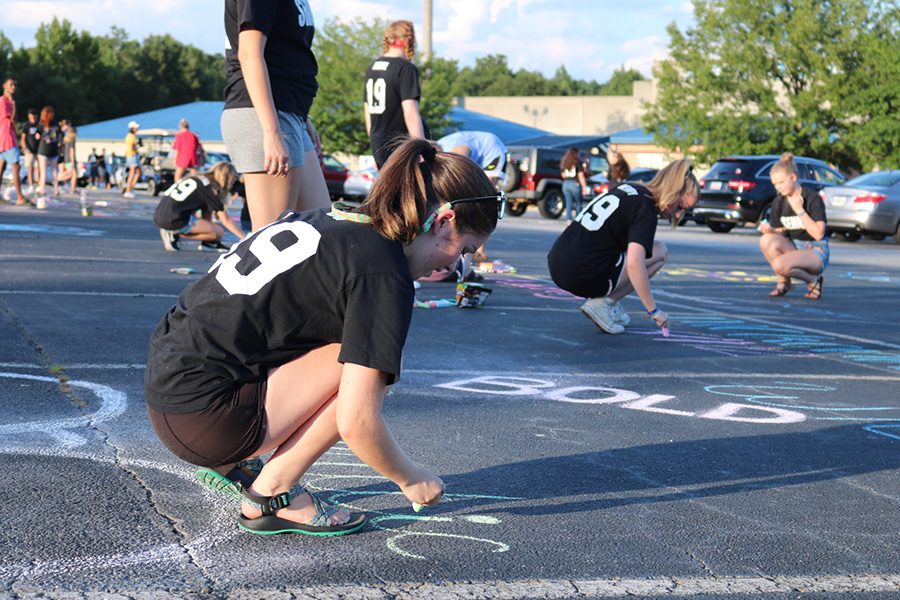 The class of 2019 wears their black senior shirts while decorating their parking spaces on the day before the beginning of school. This officially starts the last year of childhood schooling for those who will graduate in May.