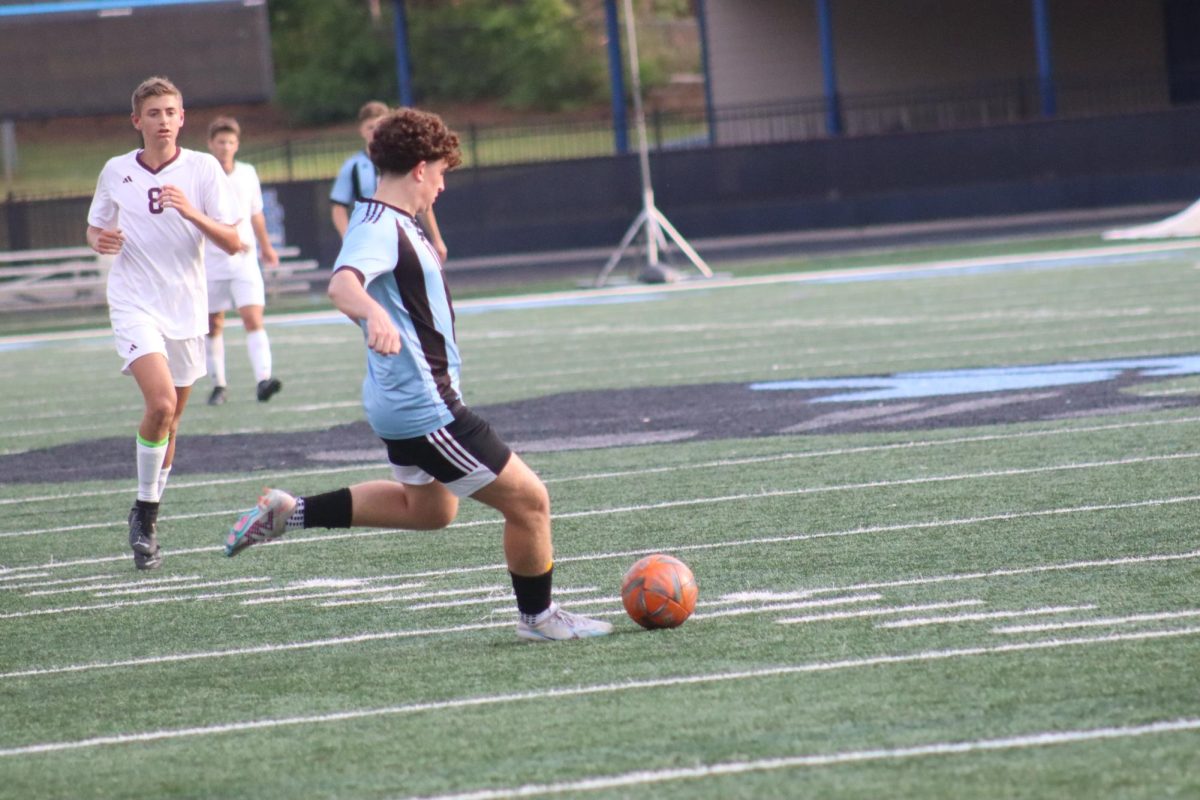 Junior Grant Ferron steals the ball from a Benedictine player. Up three goals early in the second half left it to the defense to shut out the opponent and win 4-0.