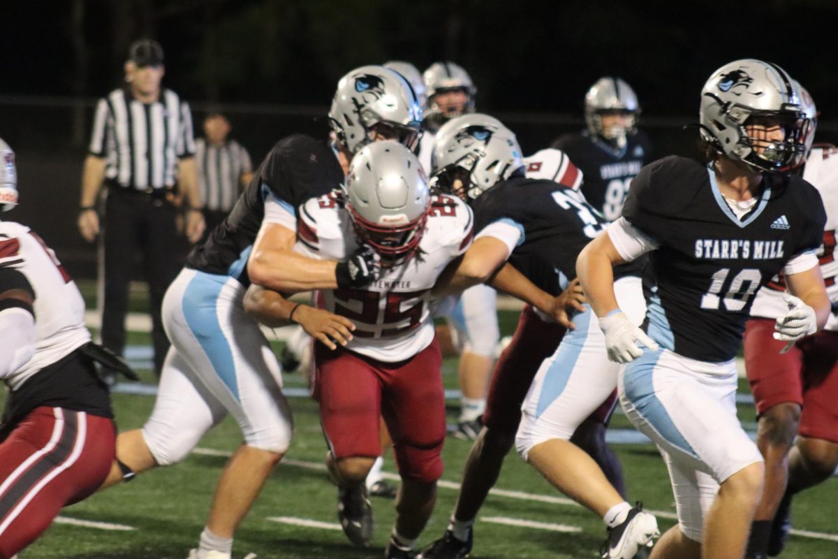 Juniors Blake Turner and Erik Lundstrom block a Whitewater player from stopping the play. The Panthers went on to win 28-7 and improved to 2-0 on the season.