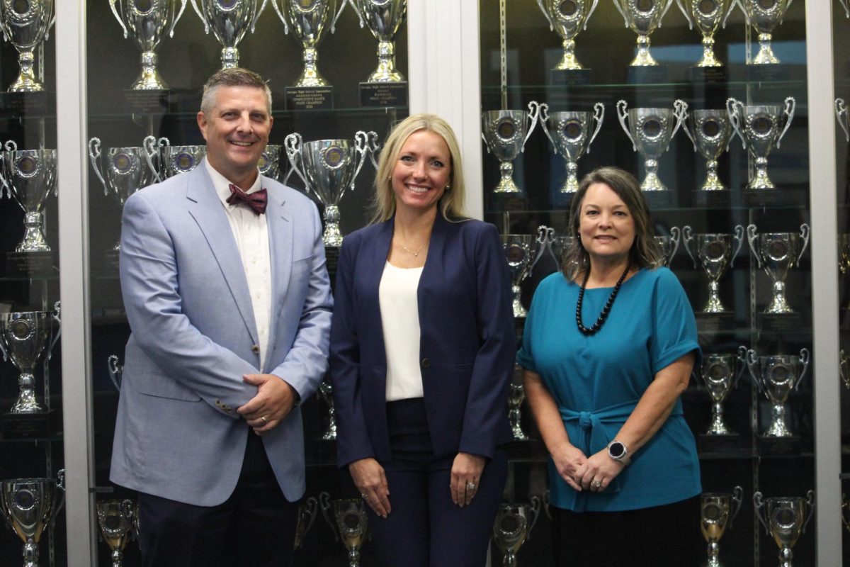 Mark Henderson (left), Jamie Voorhies (middle), and Jeannie Inagawa (right) pose for a photo in the front office of Starr’s Mill High School. For the first time, all three schools on Panther Path have new principals in the same year.