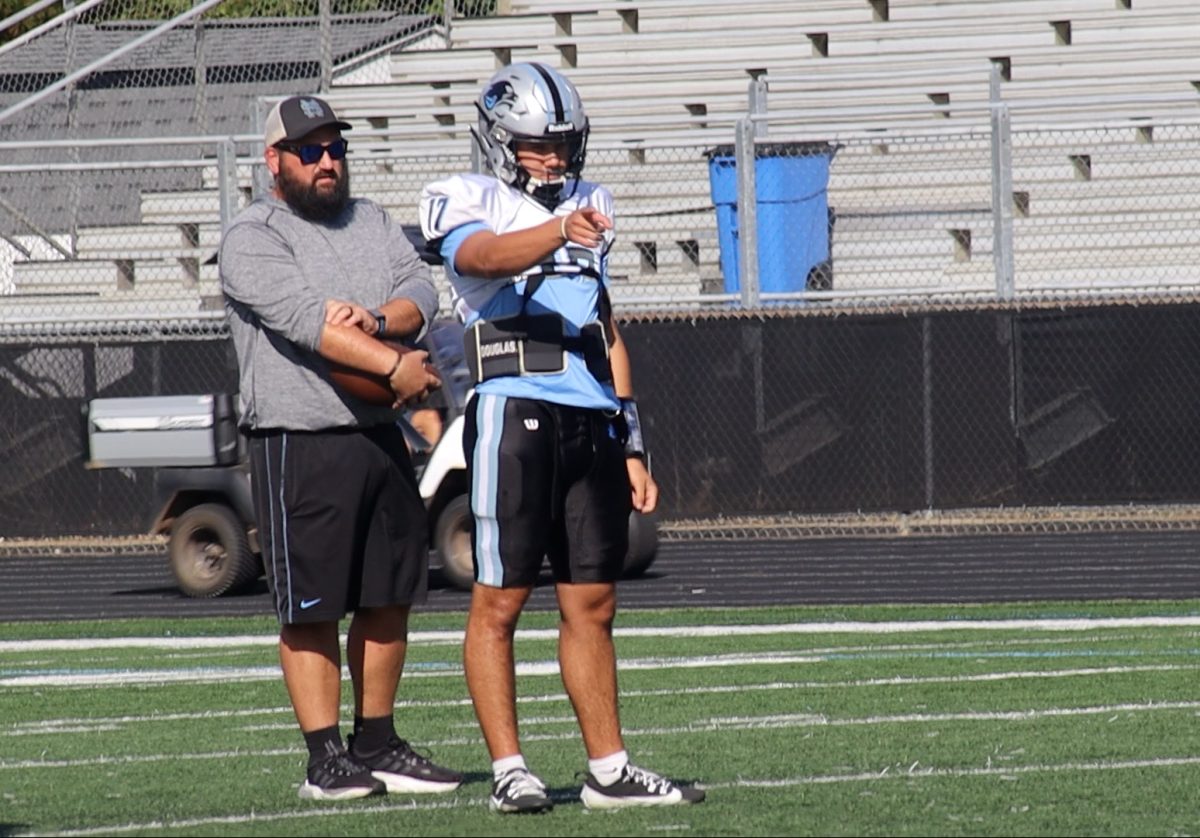 Senior quarterback Logan Inagawa points during a drill at practice before the Central Carrollton game. Inagawa went on to score all five of the team’s touchdowns in a thrilling 38-35 win over Central Carrollton. The Panthers remain undefeated and sit atop the region standings.