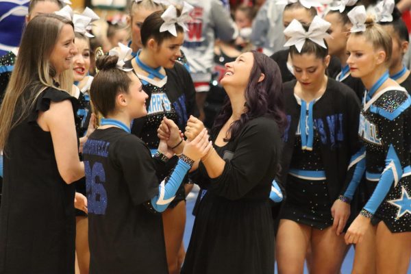 Junior Natalie McDonnell and assistant coach Nicole Scott celebrate. The girls placed second for their class. 