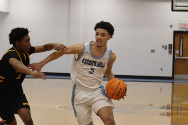 Senior Jory Williams pushes past a Tiger defender. Refining the fundamentals helped Starr’s Mill in the 74-53 win.