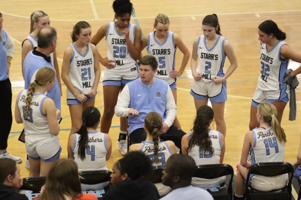 New head coach Brandon Cerezola talks to the team during a timeout. The Starr’s Mill Lady Panthers went on to defeat the Jonesboro Lady Cardinals 58-22. 