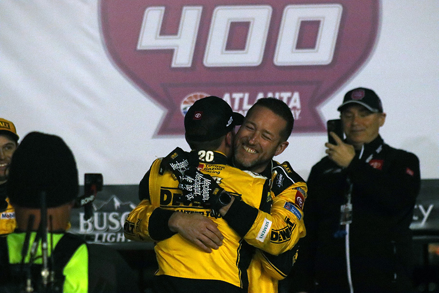 Crew chief hugs Christopher Bell, winner of the Ambetter Health 400. Bell drives the No. 20 Joe Gibbs Racing DEWALT Toyota.