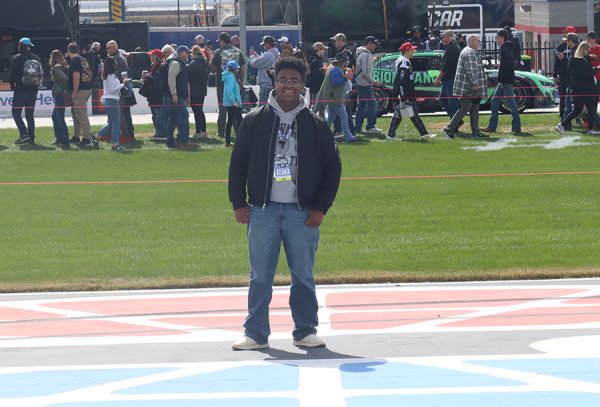 I pose for a photo on the frontstretch at Atlanta Motor Speedway. Alongside fellow Editor-in-Chief Crista Alarcon and Editor Ella Bissonnette, I covered an entire NASCAR race weekend. From that experience, I got to see the appeal of NASCAR and the stories within each race.