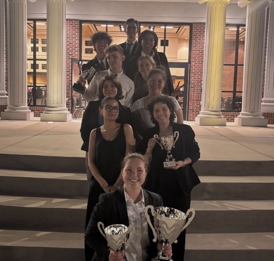 The speech and debate team poses with a myriad of trophies. This year, Starr’s Mill earned two championships, the first two under head coach Terence Fitzgerald. Photo via Instagram (@smhs.debate)