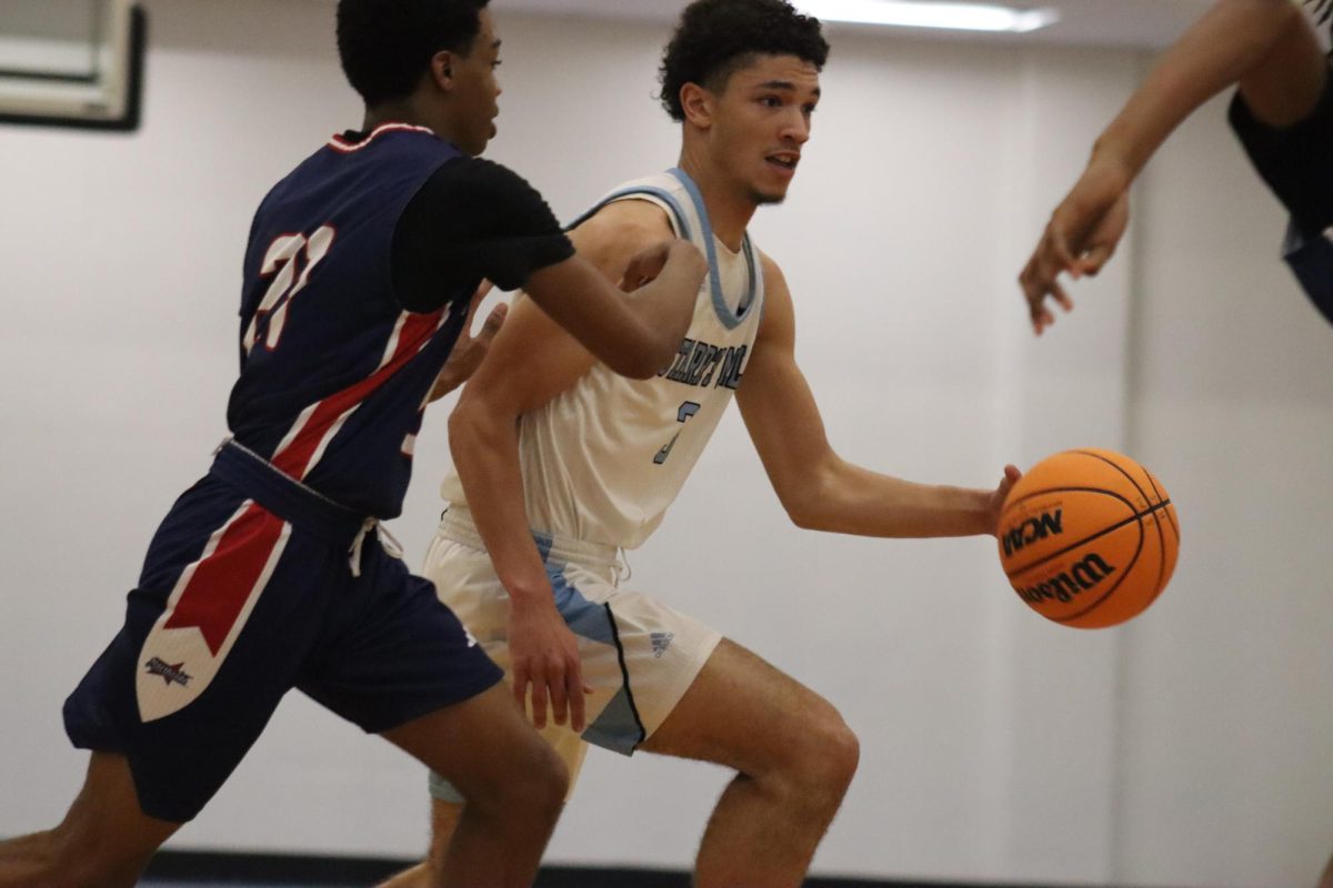 Senior Jory Williams steals the ball and drives down the court. The Panthers defeated the Patriots last Friday with a refined game plan.