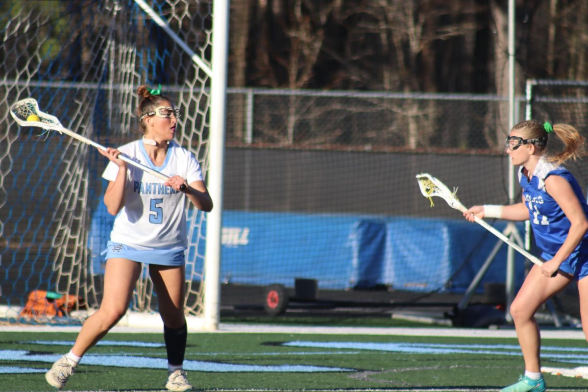 Freshman Mia Marshall prepares to pass the ball to a nearby teammate. At the beginning of this week, Starr’s Mill won a close game against Mt. Paran, 17-13. 