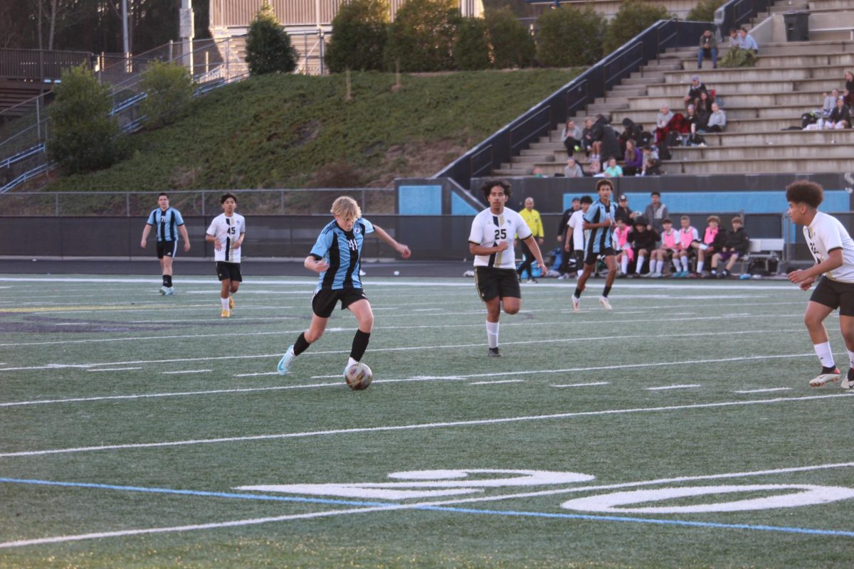 Freshman Tate Shively tries to close the distance by making a pass. He had a major part in setting up the goal in the first half. 